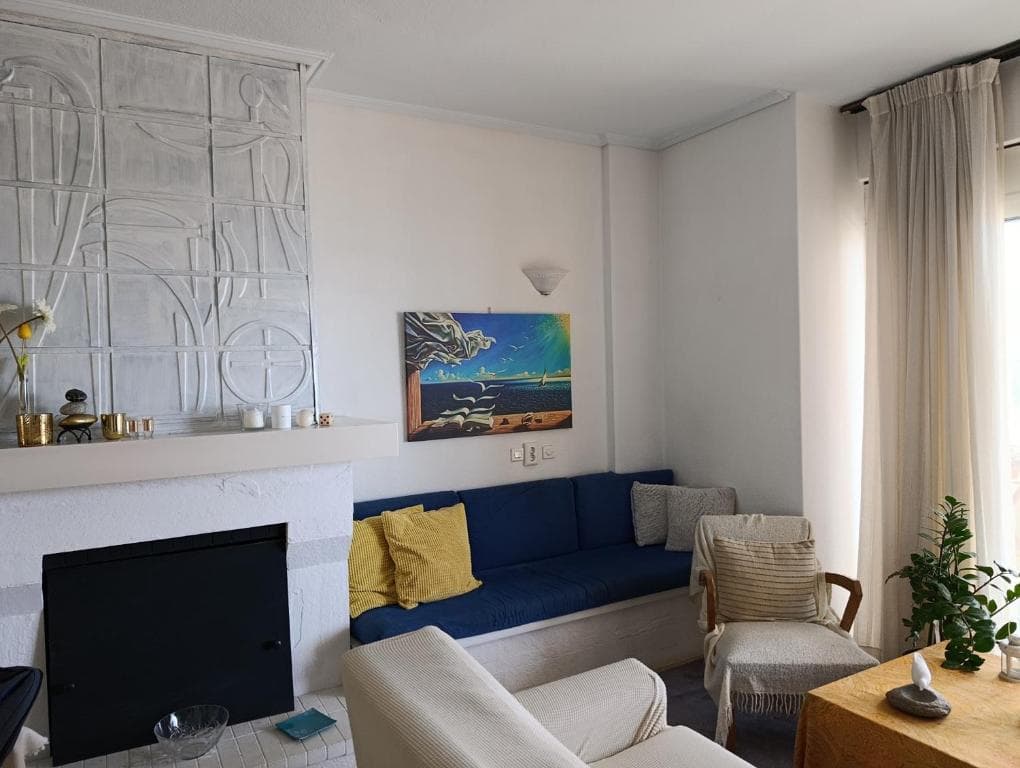 Bright open-plan living room of a Surf Apartments Artemida sea-view apartment